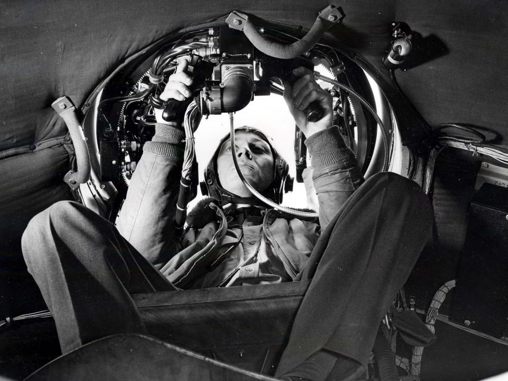 Airmen in gunner's seat in aircraft
