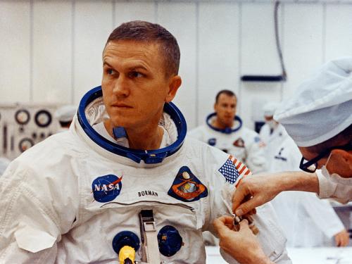 Frank Broman suiting-up in spacesuit in preparation for a mission.