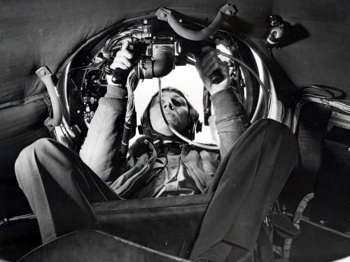 Airmen in gunner's seat in aircraft