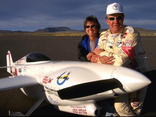 Jon and Patricia Sharp stand next to their plane, Nemesis.