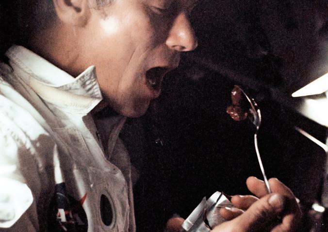 Astronaut Eugene Cernan dines aboard the Apollo 17 command module.