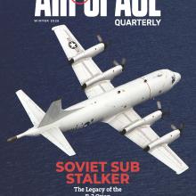 A white, four-propeller airplane with U.S. Navy markings and a distinctive pointy tail flies over the dark blue ocean. At the bottom of the magazine cover, in bold red letters, is a headline: Soviet Sub Stalker.